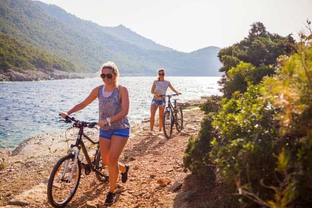 two women cycling Mljet National Park in Croatia