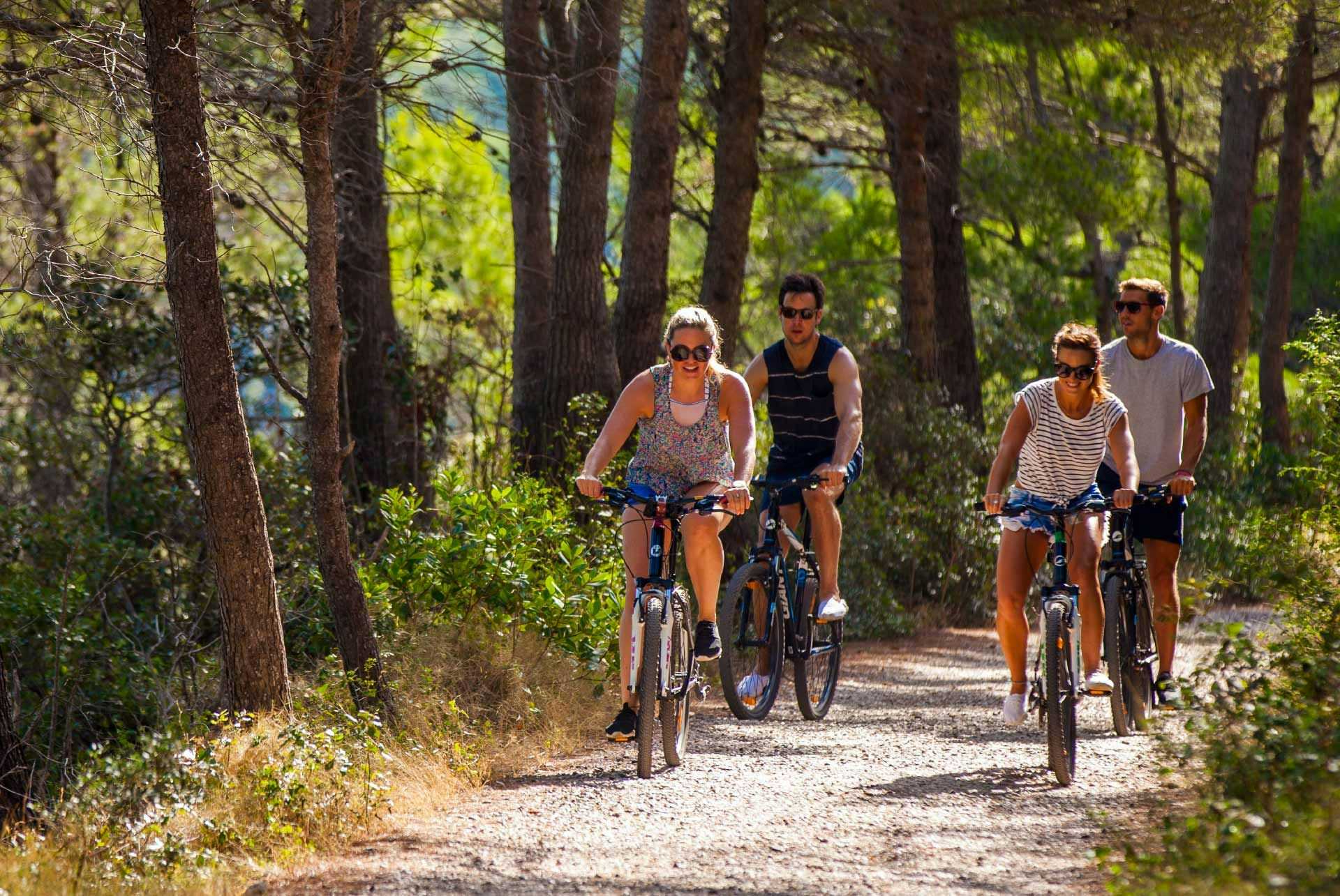 Group of people cycle through Mjlet National Park in Croatia