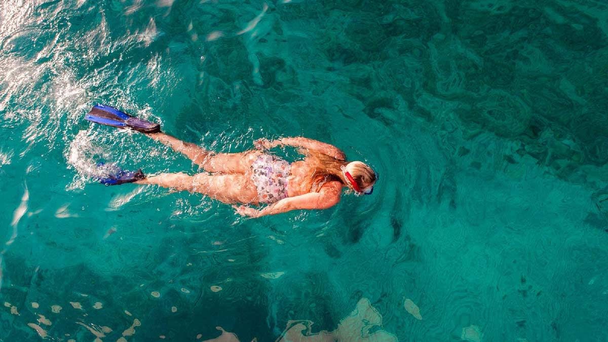 Woman snorkelling in clear blue water