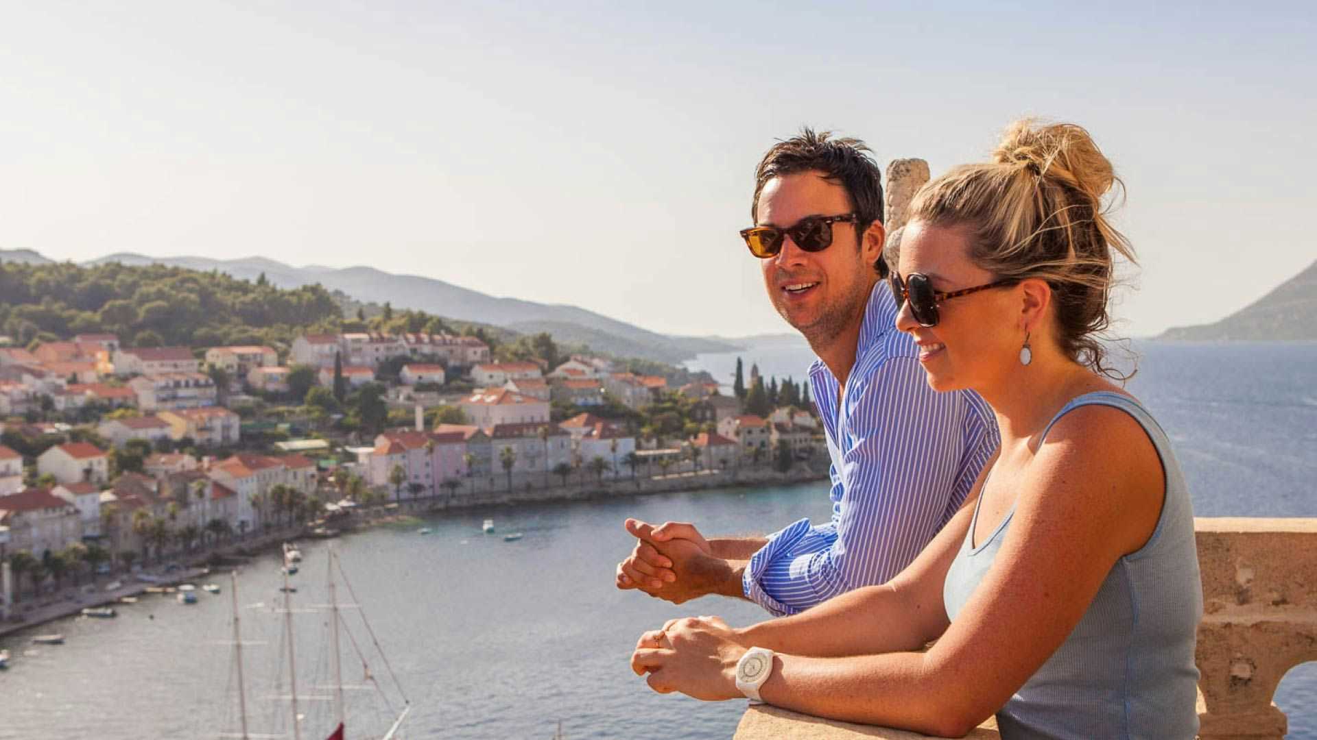 Couple up a tower in Korcula looking at the view