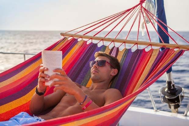 Man reads book on a yacht