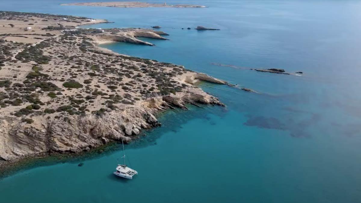 Yacht Getaways catamaran anchored in a beautiful bay in the Cyclades Islands of Greece