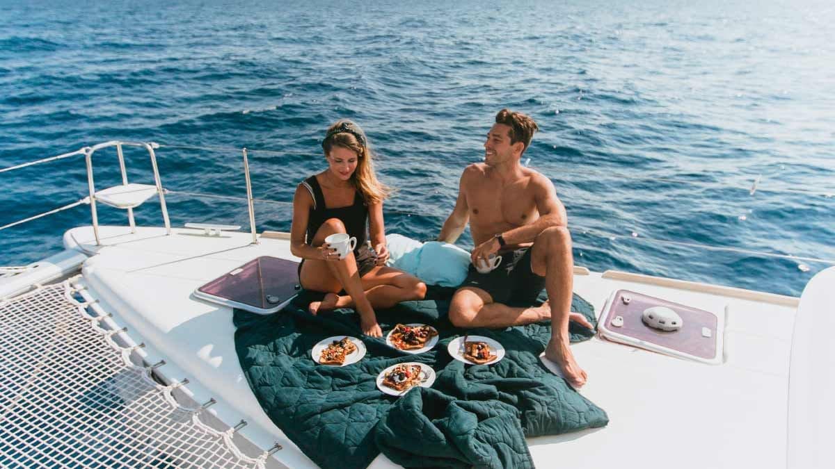 Couple enjoy lunch together on a Yacht Getaways catamaran