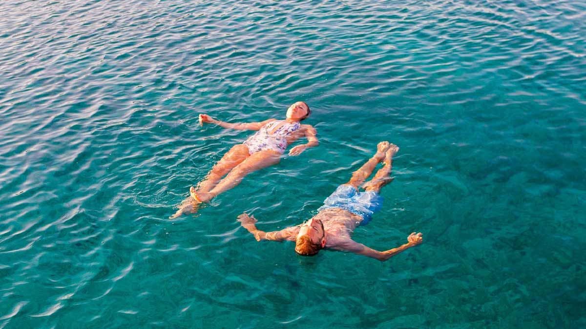 Couple floating in the sea in Croatia
