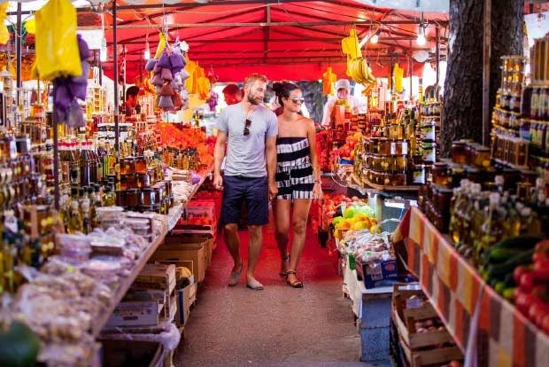Picture of a couple walking through a local Croatian food market