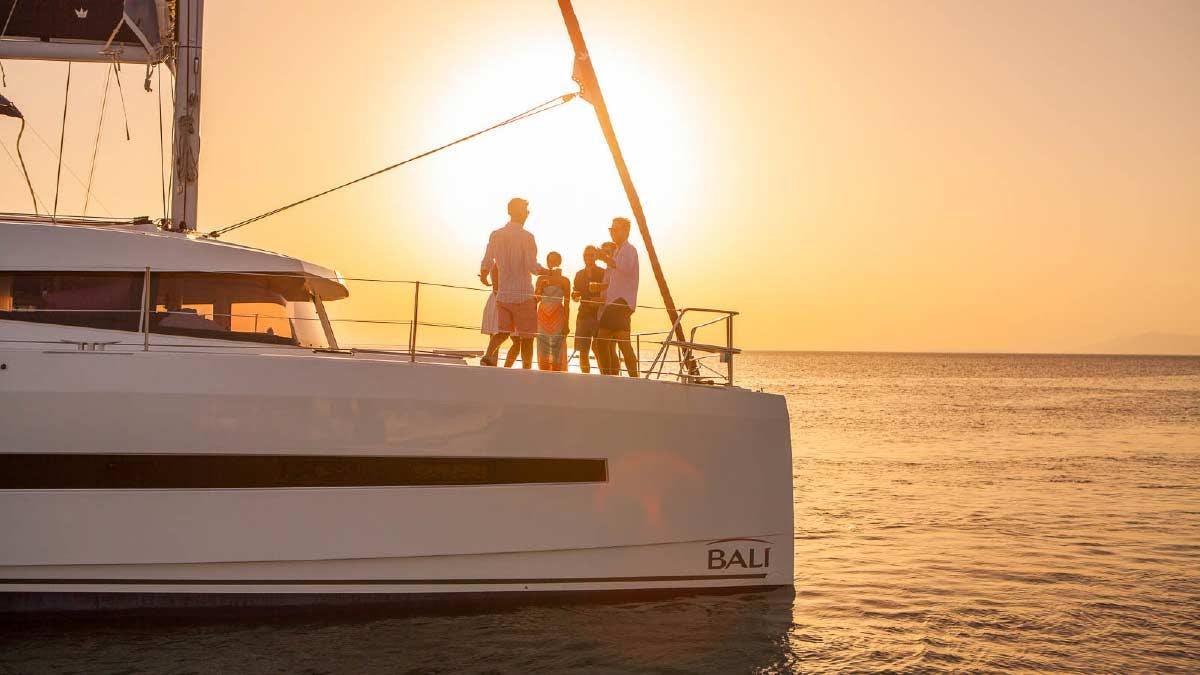 Guests enjoy sunset drinks on a catamaran