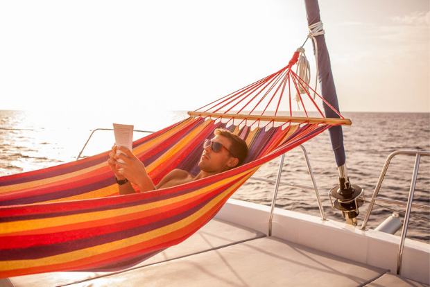 Man relaxing in a hammock on a yacht