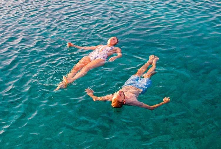 Couple floating in the sea in Croatia