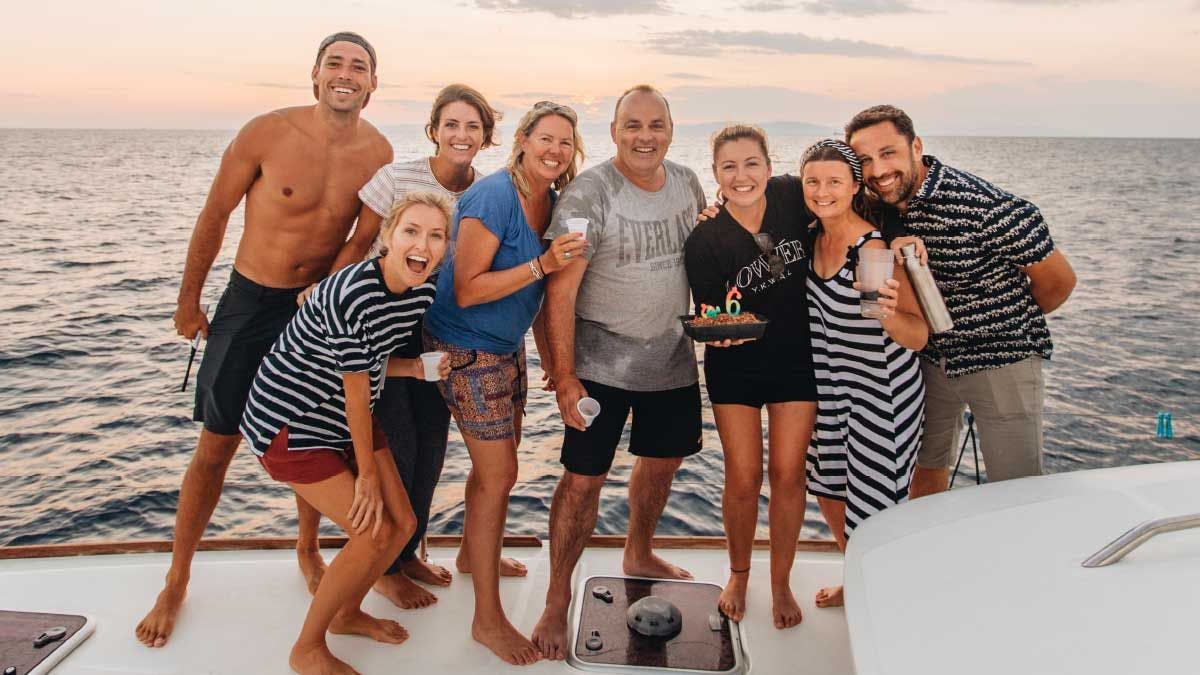 Group of guests celebrate onboard a catamaran