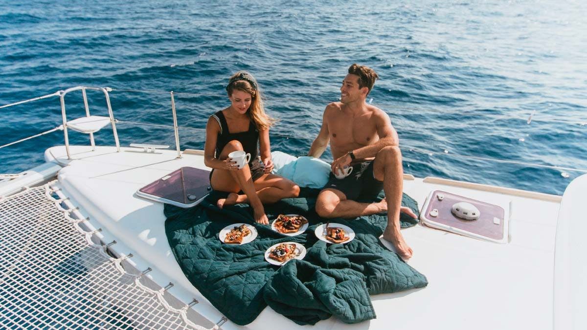 Guests enjoying lunch on a Yacht Getaways catamaran