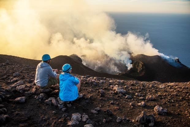 Hikers sit on top of Mount Stromboli in Sicily
