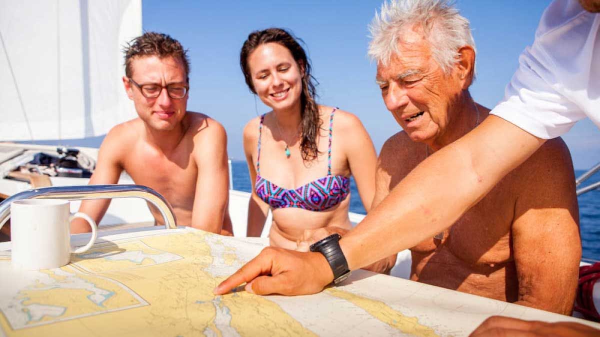 Family being shown the sailing route by their skipper